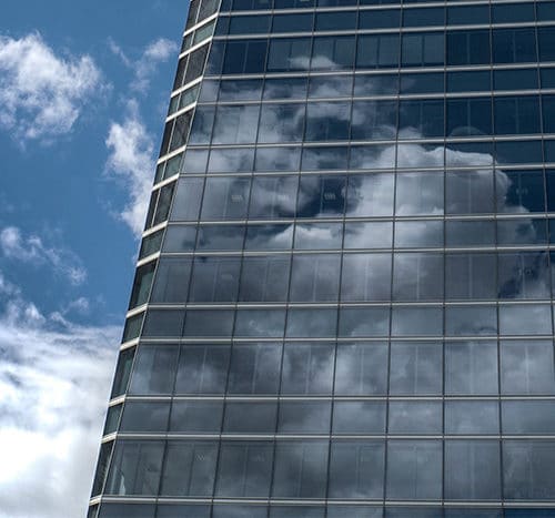 Building with cloud reflection