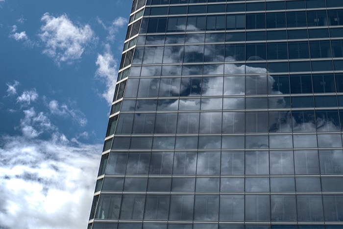 Building with cloud reflection